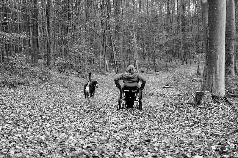 Tracey Ferguson and her dog Koda exercising outside in the woods