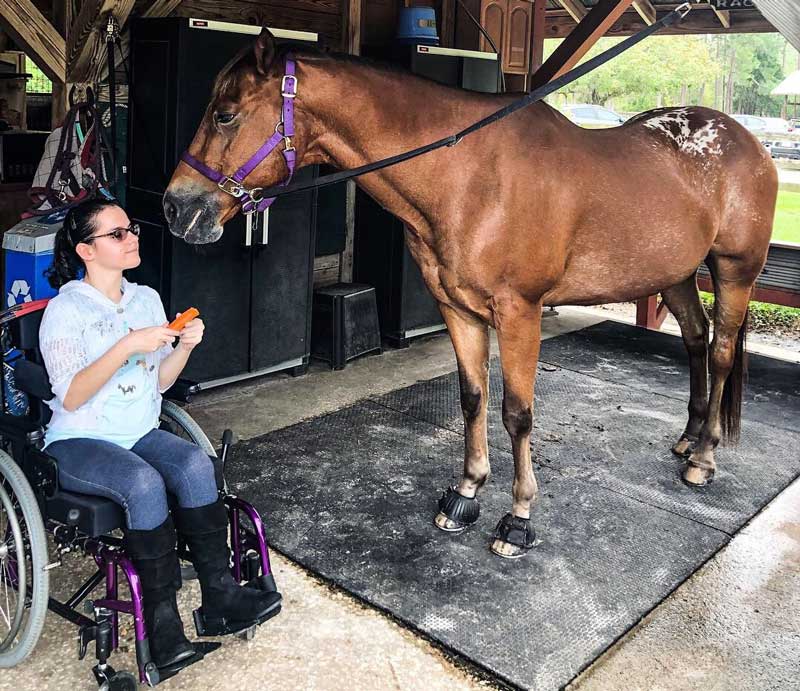 Bryanna caring for a horse