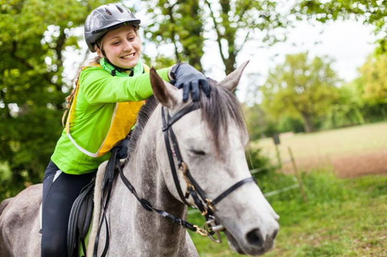 A woman riding a horse