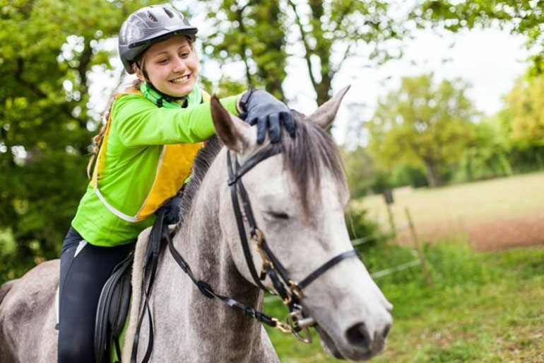 A woman riding a horse