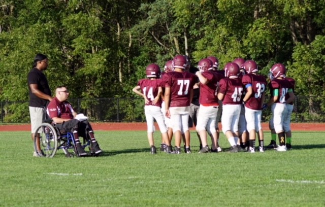 Stephen coaching young football players