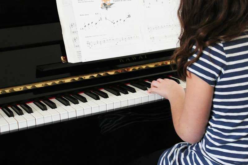 Young child playing the piano